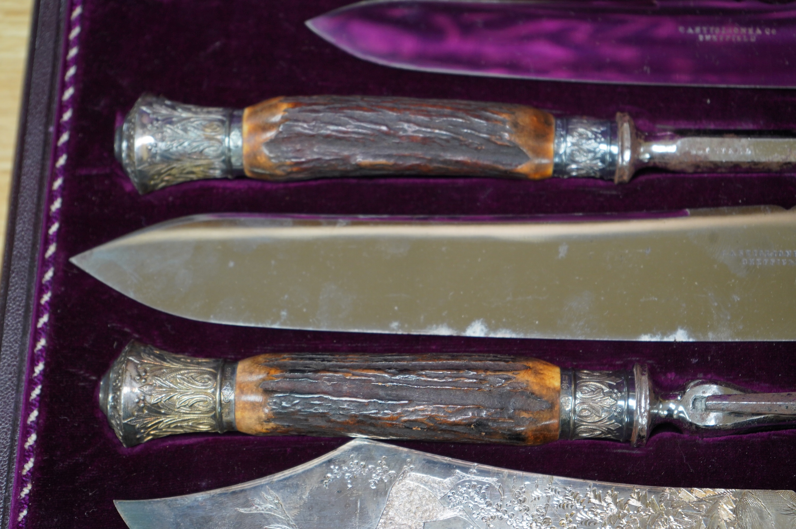 A gilt tooled leather cased stag handled silver collared carving set, case 44cm wide. Condition - good